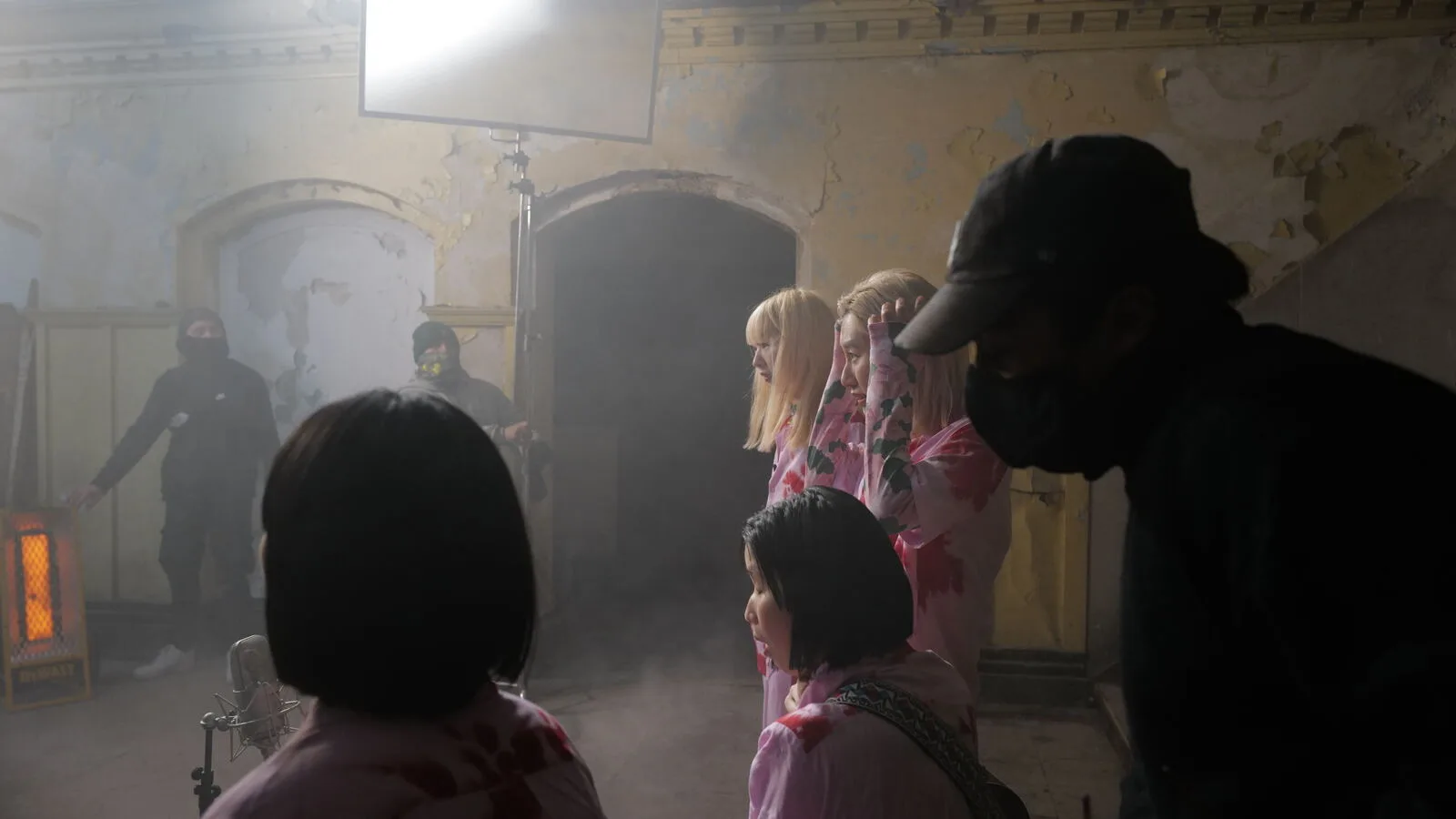 Performers in a misty room