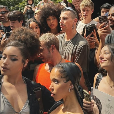 A dense crowd at a Brooklyn pop-up, several people holding Songs That Found Me cards